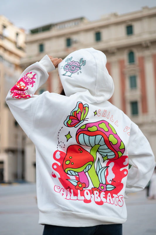 Trippy white oversized hoodie spreading imaginative chill vibes with whimsical mushrooms, happy brain visuals and cosmic